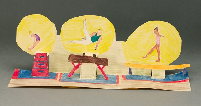 A recycled file folder makes the gymnasts in this project pop up!