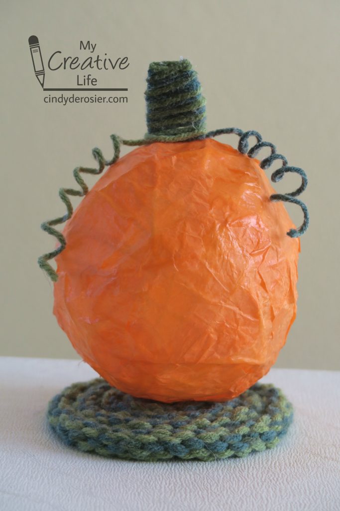 Use yarn to make a cool pumpkin decoration.