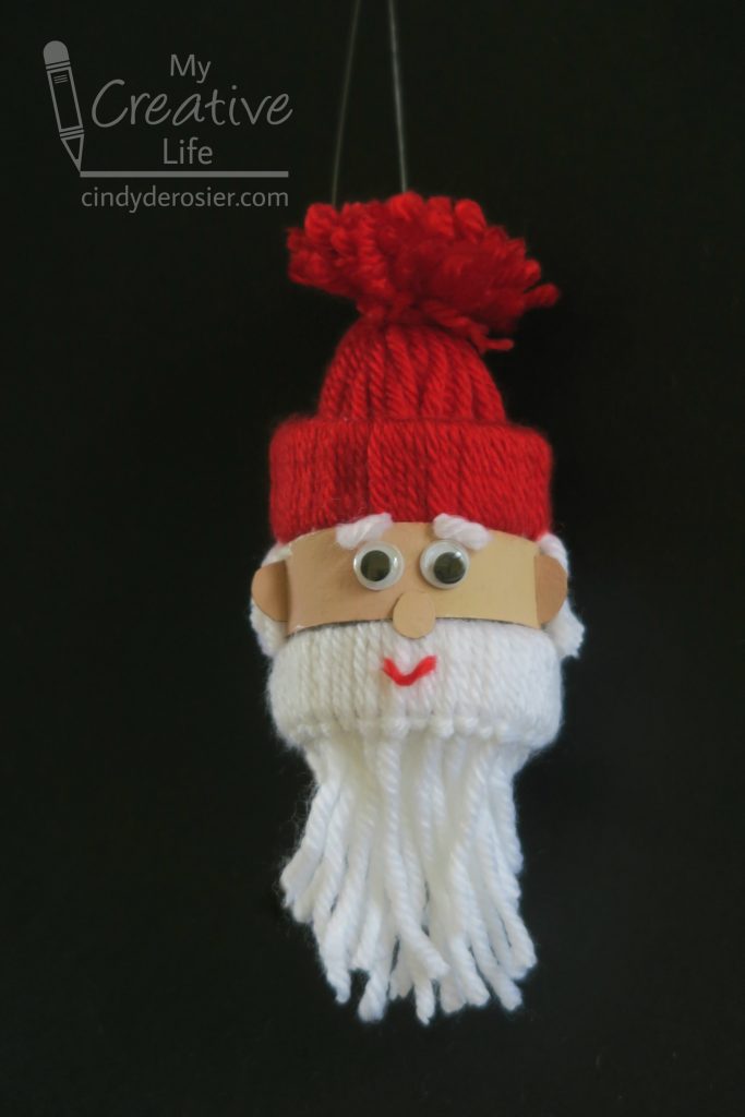 Turn a cardboard tube and some yarn into an adorable Santa ornament.